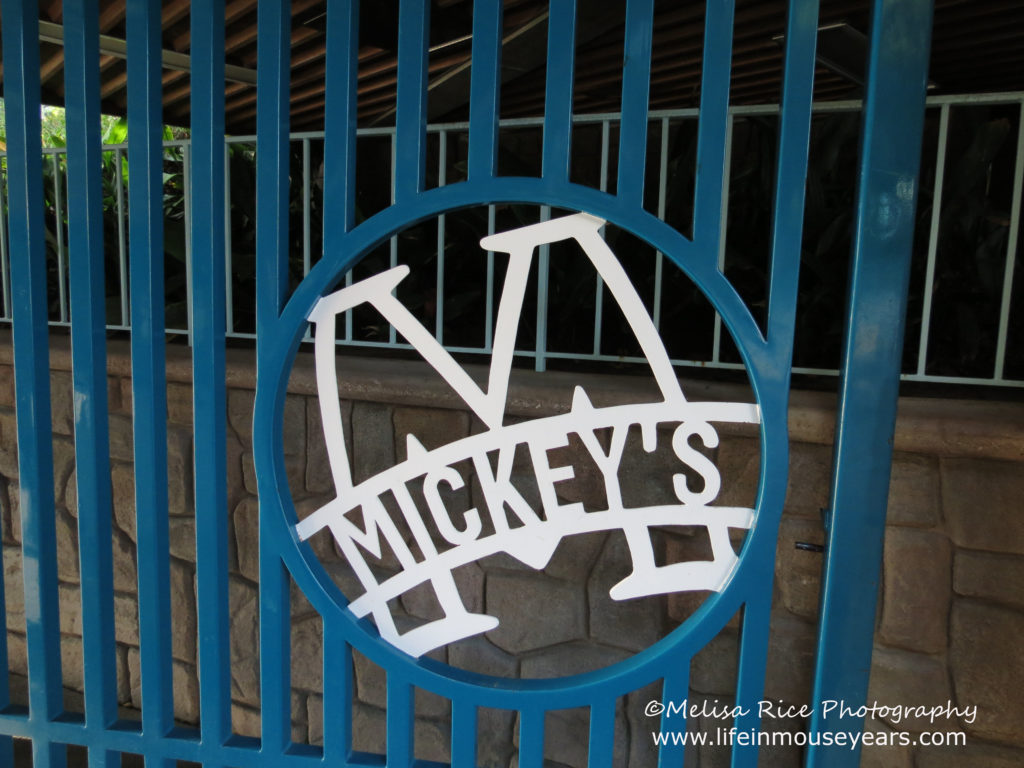 Entrance gate to Mickey's Toontown. Blue with White wording that says Mickey's.