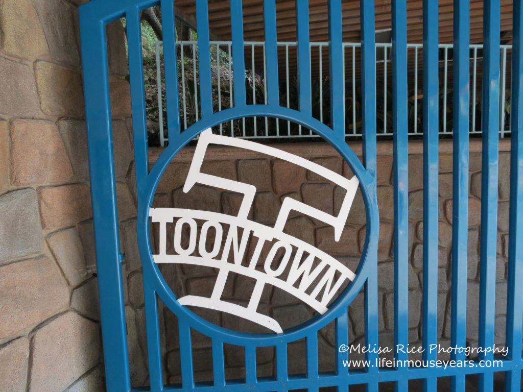 Entrance gate to Mickey's Toontown. Blue with white writing that says Toontown.
