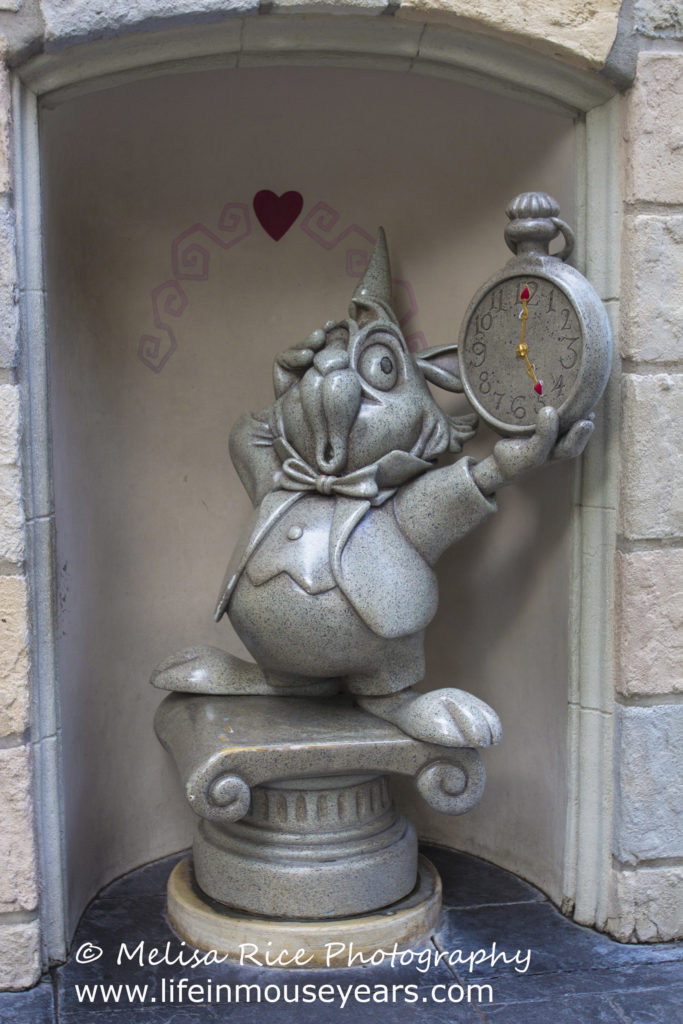 The White Rabbit and his pocket watch in Disneyland. Discovering statues around Disneyland.